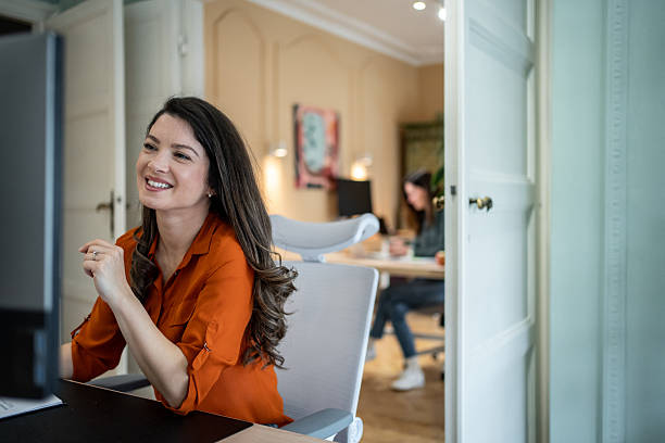 istock Smiling businesswoman working on computer in modern office 2207213311
