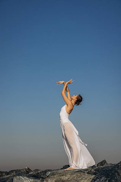 istock Graceful Dancer Posing Outdoors Against a Clear Blue Sky 2207213815