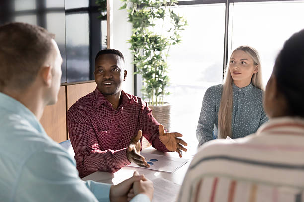 istock Serious young African American businessman talking to diverse group 2207216825