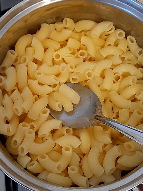 istock Cooked pasta in cooking pan with spoon 2207217453