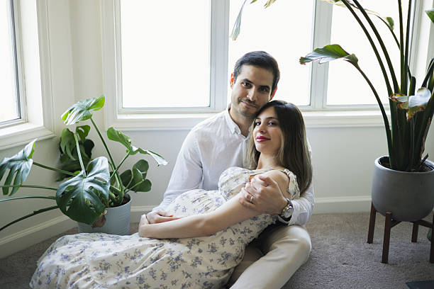 istock 8 Months Pregnant - Middle Eastern Tunisian Couple - Cuddling 2207220091