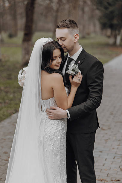istock A bride and groom are hugging each other on a brick walkway 2207221074