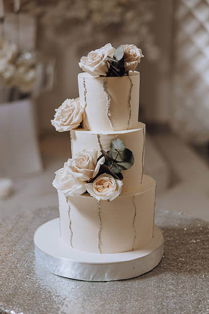 istock A three tier wedding cake with white frosting and flowers on top 2207221227