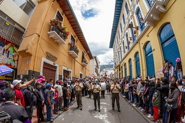 Quito, Pichincha, Ecuador - April 15, 2022: Police officers playing musical instruments during the procession of Jesus del Gran Poder in Quito, Ecuador, a traditional Holy Week celebration attracting large crowds