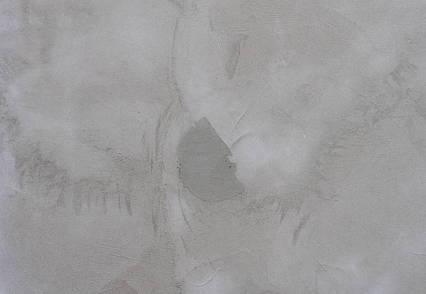 istock Close-up of a gray concrete wall with rough texture and irregular patterns. The surface has a natural, industrial 2207223680