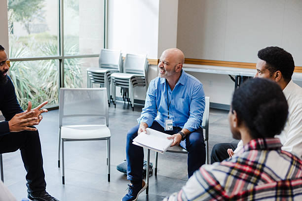 istock Group Therapy Session: Diverse Adults Discussing Mental Health 2207226436