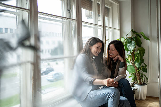 istock Two businesswomen sharing a lighthearted moment with digital tablet 2207226650