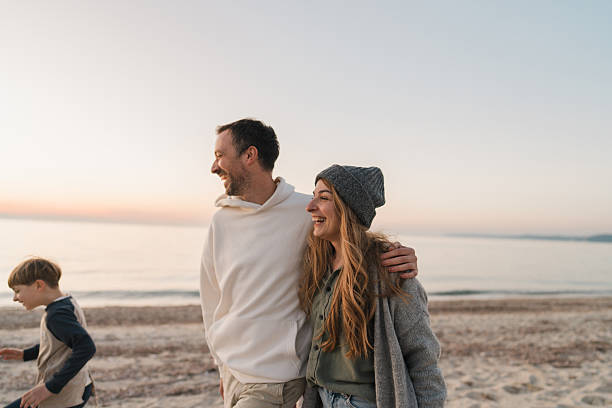 istock Family walk down the beach 2207228933