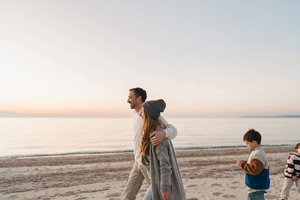 istock Family walk down the beach 2207228951