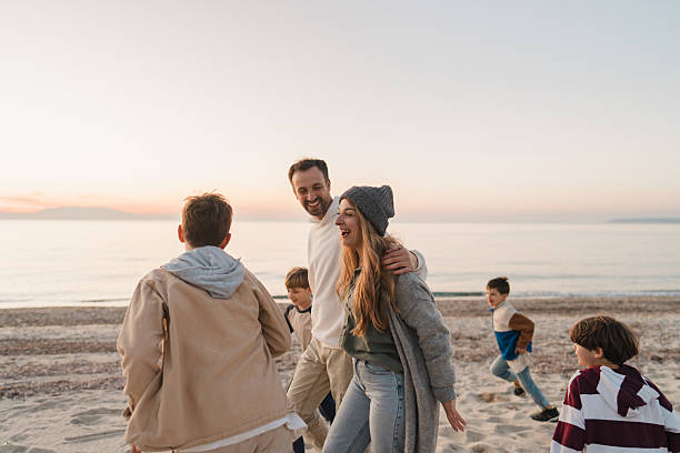 istock Family walk down the beach 2207228959