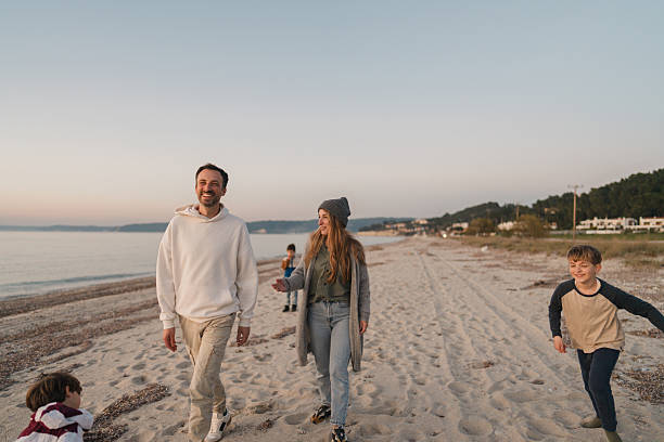 istock Family walk down the beach 2207228965