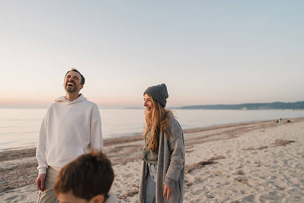 istock Family walk down the beach 2207228979