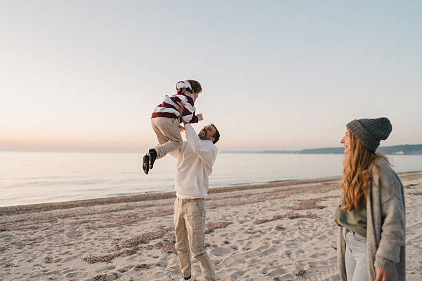 istock Family walk down the beach 2207228986
