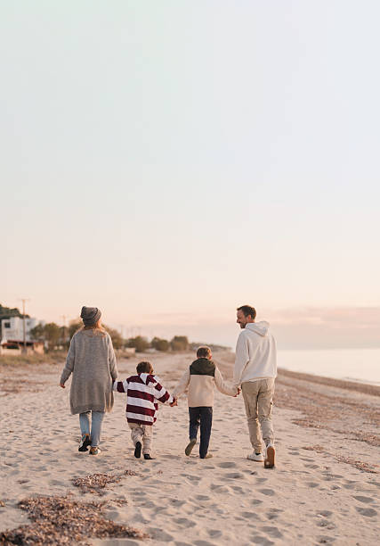 istock Family walk down the beach 2207228989