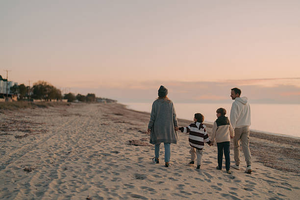 istock Family walk down the beach 2207229004
