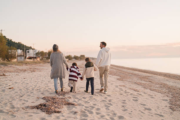 istock Family walk down the beach 2207229020
