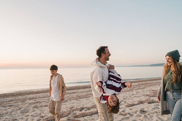 istock Family walk down the beach 2207229022
