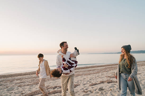 istock Family walk down the beach 2207229024