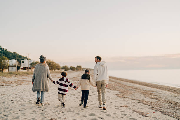 istock Family walk down the beach 2207229025
