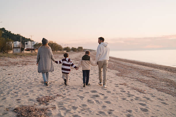 istock Family walk down the beach 2207229027