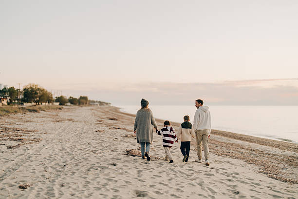 istock Family walk down the beach 2207229028