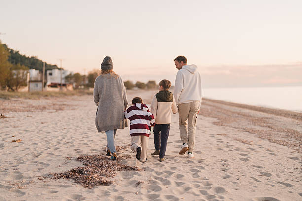 istock Family walk down the beach 2207229030