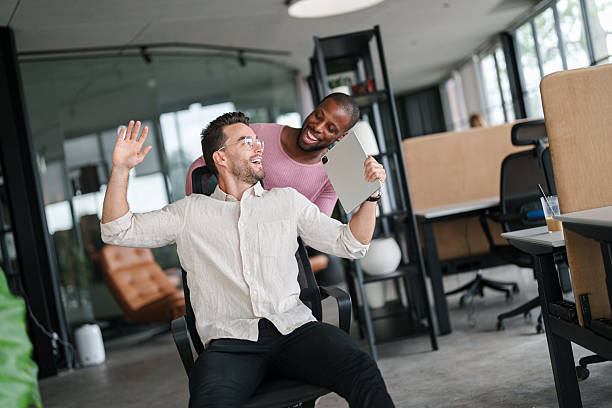 istock Two Colleagues Laughing in Modern Office Space 2207229878