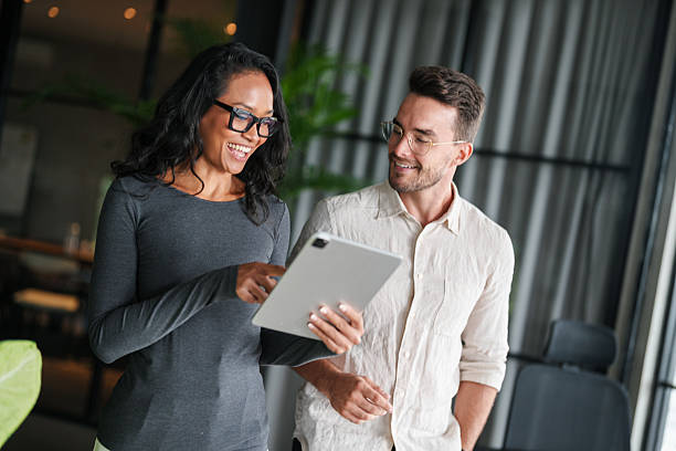 istock Diverse Professionals Share Digital Insights In Modern Office Space 2207229900