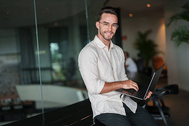 istock Confident Young Man Working on Laptop in Modern Office 2207229912