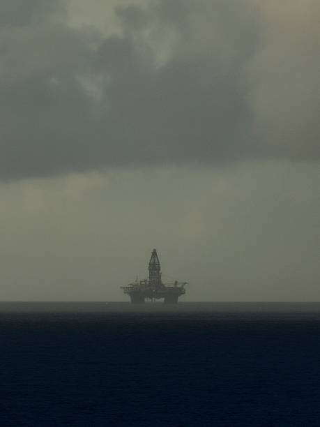 A distant oil rig works under a thunderous sky in the Caribbean Sea near Venezuela.