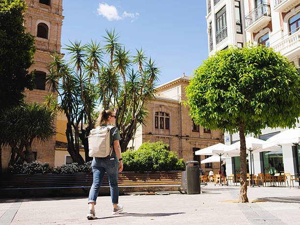 Walking through city, exploring alone on a solo trip, young student.