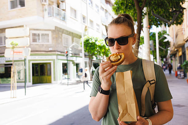 istock Student eating local cuisine while exploring the new city. 2207231952