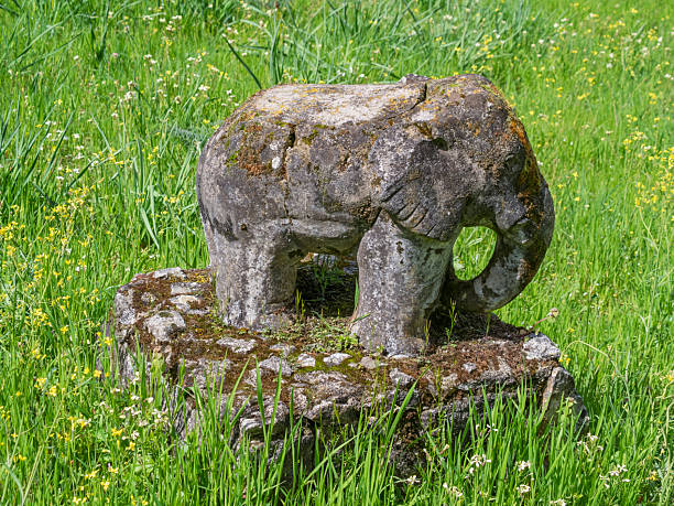Elephant statue carved from granite stone in a children's playground