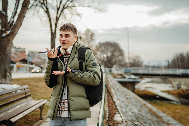 istock Young adult man student smile and use cellphone 2207236343