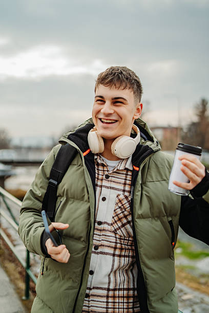 istock Young adult man student smile and use cellphone 2207236381