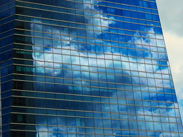 Skyscraper - glass building .Corporate Buildings. Skyscraper located in Madrid city, Spain. Interesting reflections in the glass windows of a building.Paseo de la castellana, main avenue of the city of Madrid from north to south, Spain