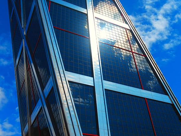 Skyscraper - glass building .Corporate Buildings. Skyscraper located in Madrid city, Spain. Interesting reflections in the glass windows of a building.Paseo de la castellana, main avenue of the city of Madrid from north to south, Spain