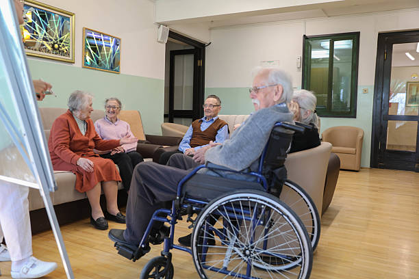 istock Therapist Leading a Group Session in a Nursing Home (80+) 2207240089