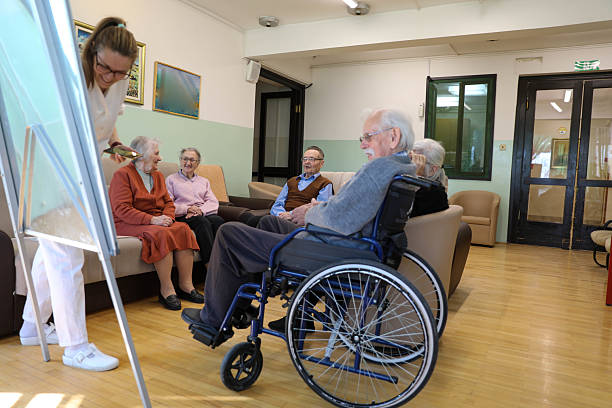 istock Therapist Leading a Group Session in a Nursing Home (80+) 2207240108