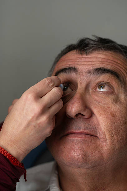 istock Doctor applying ocular prosthesis to patient eye 2207242038