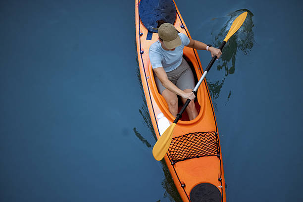 istock Active Individual Kayaking on Tranquil Water in Nature 2207242214