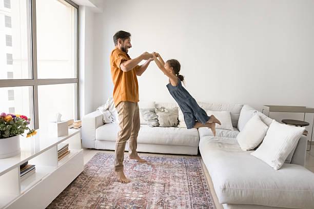 istock Excited happy dad holding daughter kids hands 2207242548