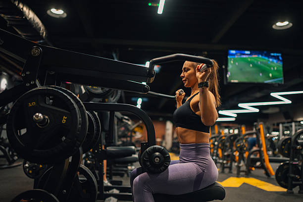 istock Determined young woman lifting weights at the gym 2207242652