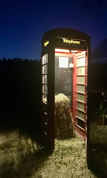 istock Classic red BT telephone box with hay inside 2207243233