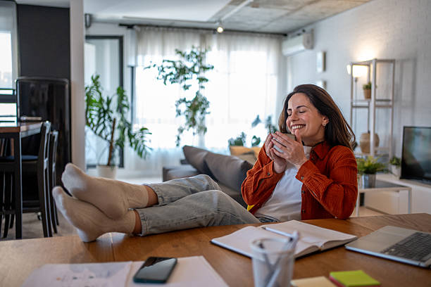 istock Freelancer enjoying a coffee break with feet up on the table at home 2207244067