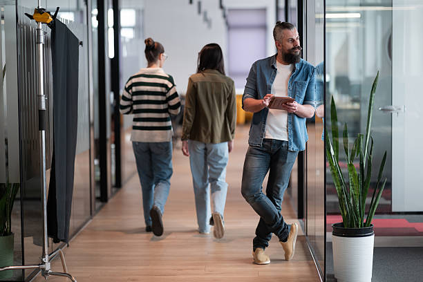 istock Senior bearded businessman, IT professional, trader, and crypto investor using a digital tablet in a modern coworking space. Tech-savvy professional working in an open office startup environment 2207244367
