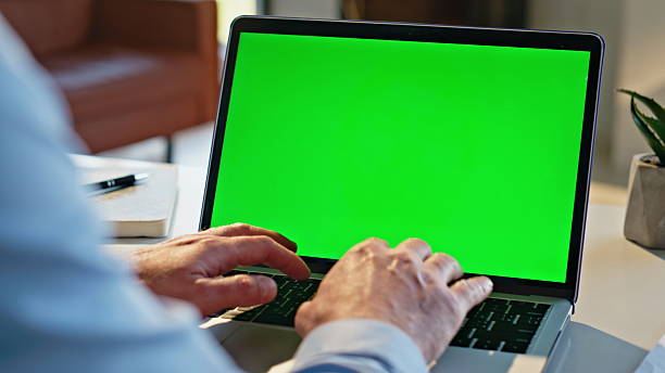 istock Man hands typing greenscreen laptop apartment closeup. Remote manager working 2207247011