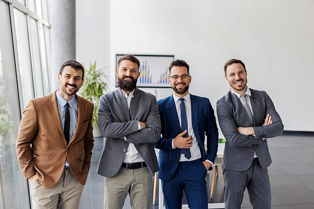 istock Male experts standing at boardroom and smiling at camera. 2207248037