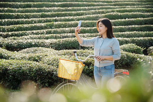 istock Asian woman is using smart phone take picture 2207248295