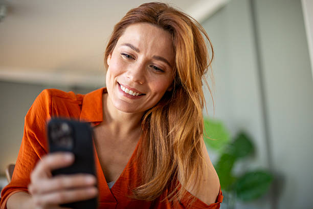 istock Happy woman looking at the phone 2207250099